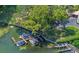 Aerial view of a waterway showing multiple boats docked along a manicured shoreline with lush trees at 100 S Interlachen Ave # 410F, Winter Park, FL 32789