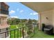 Relaxing balcony view with outdoor seating overlooking lush greenery, pool, and condo buildings at 100 S Interlachen Ave # 410F, Winter Park, FL 32789