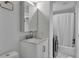 Bright bathroom featuring a marble countertop vanity, and a shower-tub combo with white shower curtain at 100 S Interlachen Ave # 410F, Winter Park, FL 32789