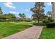 Well-maintained brick sidewalk meanders through lush green lawns, trees and landscaping at 100 S Interlachen Ave # 410F, Winter Park, FL 32789