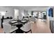 Modern dining room with a sleek black table and stylish white chairs, perfect for gatherings at 100 S Interlachen Ave # 410F, Winter Park, FL 32789