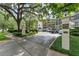 Exterior view of the building showcasing mature trees and convenient parking at 100 S Interlachen Ave # 410F, Winter Park, FL 32789