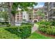 Exterior view of the building showcasing lush landscaping and convenient parking at 100 S Interlachen Ave # 410F, Winter Park, FL 32789