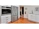 Bright kitchen featuring stainless steel appliances, white cabinets, and tiled floor at 100 S Interlachen Ave # 410F, Winter Park, FL 32789