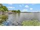 Wide view of a calm lake with lily pads and distant shoreline, creating a sense of tranquility at 100 S Interlachen Ave # 410F, Winter Park, FL 32789
