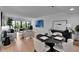Bright living room featuring hardwood floors, neutral colors, and a sliding glass door to a private balcony at 100 S Interlachen Ave # 410F, Winter Park, FL 32789