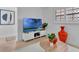 Comfortable living room with entertainment center, plants, and plenty of natural light at 100 S Interlachen Ave # 410F, Winter Park, FL 32789