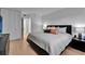 Comfortable main bedroom with modern decor, hardwood floors, and closet at 100 S Interlachen Ave # 410F, Winter Park, FL 32789