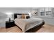 Calm main bedroom featuring a platform bed, neutral tones, natural light, and hardwood floors at 100 S Interlachen Ave # 410F, Winter Park, FL 32789