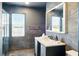 Modern bathroom with dark marbled tile, frameless shower, and stylish vanity at 1002 Lake Elbert Se Dr, Winter Haven, FL 33880