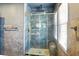 Contemporary shower featuring marble-style tile, a built-in niche, and gold accents at 1002 Lake Elbert Se Dr, Winter Haven, FL 33880