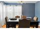 Elegant dining room featuring dark wood table, upholstered chairs, and large windows at 1002 Lake Elbert Se Dr, Winter Haven, FL 33880