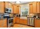 Modern kitchen with stainless steel appliances, custom cabinets, and a farmhouse sink offering style and functionality at 1002 Lake Elbert Se Dr, Winter Haven, FL 33880