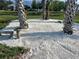 Unique landscaping featuring palm trees and crushed shells offering a tranquil outdoor space at 1002 Lake Elbert Se Dr, Winter Haven, FL 33880