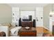 Elegant living room featuring custom built-in bookshelves, hardwood floors, and a cozy fireplace at 1002 Lake Elbert Se Dr, Winter Haven, FL 33880