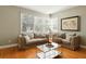 Cozy living room with comfortable seating, large windows, and hardwood floors offering a relaxing retreat at 1002 Lake Elbert Se Dr, Winter Haven, FL 33880