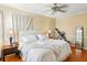 Serene main bedroom with neutral tones, hardwood floors, ceiling fan, and ample light at 1002 Lake Elbert Se Dr, Winter Haven, FL 33880