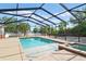 Inviting screened pool area with clear blue water and a relaxing spa, surrounded by lush landscaping at 1002 Lake Elbert Se Dr, Winter Haven, FL 33880