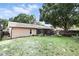 Spacious backyard with mature trees, screened-in porch, and plenty of room for outdoor activities at 10049 Custer Cir, Orlando, FL 32817