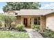 Inviting front exterior with brick and siding, manicured lawn, and a pathway to the entrance at 10049 Custer Cir, Orlando, FL 32817