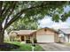 Charming single-story home with a well-manicured lawn, mature trees, and a two-car garage at 10049 Custer Cir, Orlando, FL 32817