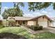 Charming single-Gathering home with brick accents, well-maintained landscaping, and a two-car garage at 10049 Custer Cir, Orlando, FL 32817