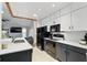 Modern kitchen with white cabinets, gray lower cabinets, stainless steel appliances, and sleek countertops at 10049 Custer Cir, Orlando, FL 32817