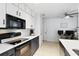 Well-lit kitchen featuring modern appliances, white cabinets, and sleek countertops at 10049 Custer Cir, Orlando, FL 32817