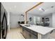 Spacious kitchen area with an island featuring a stainless steel sink and views into the dining area at 10049 Custer Cir, Orlando, FL 32817