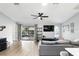 Spacious living room with wood flooring, modern ceiling fan, and sliding glass doors to the patio at 10049 Custer Cir, Orlando, FL 32817