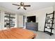 Inviting main bedroom with access to screened patio, dresser and a decorative ladder for storage at 10049 Custer Cir, Orlando, FL 32817