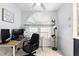 Bright office space with large windows, a ceiling fan, and a desk with computer setup at 10049 Custer Cir, Orlando, FL 32817
