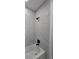 Updated bathroom with tub and shower with tile surround and matte black fixtures at 1005 Randall St, Orlando, FL 32805