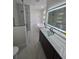 Sleek bathroom features a glass-enclosed shower, soaking tub, and modern vanity with illuminated mirror at 1005 Randall St, Orlando, FL 32805