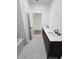 Bathroom featuring double sinks with granite countertops, tiled floors, and modern fixtures near bathtub at 1005 Randall St, Orlando, FL 32805
