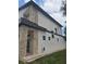 Modern two-story home featuring stone accents, a dark roofline, and a well-manicured lawn at 1005 Randall St, Orlando, FL 32805
