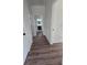 Hallway featuring hardwood floors and white trim, leading to other rooms in the house at 1005 Randall St, Orlando, FL 32805