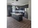 Modern kitchen with dark cabinetry, stainless steel appliances, quartz countertops, and pendant lighting at 1005 Randall St, Orlando, FL 32805
