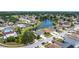 Overhead view of houses in a lakeside residential neighborhood with mature trees and landscaping on a sunny day at 1021 Whalebone Bay Dr, Kissimmee, FL 34741
