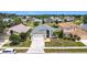 Aerial view of home with lush landscaping and lake view; a beautiful home in a desirable neighborhood at 1021 Whalebone Bay Dr, Kissimmee, FL 34741