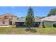 View of home's backyard, featuring a screened-in patio and mature landscaping at 1021 Whalebone Bay Dr, Kissimmee, FL 34741
