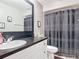 Updated bathroom features a stylish vanity and mirror and a shower behind a decorative curtain at 1021 Whalebone Bay Dr, Kissimmee, FL 34741