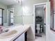 Well-lit bathroom features a large vanity, medicine cabinet and a separate toilet and shower area with shelving at 1021 Whalebone Bay Dr, Kissimmee, FL 34741