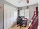 This bedroom features a wood floor, ceiling fan, a window and large closet at 1021 Whalebone Bay Dr, Kissimmee, FL 34741
