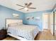 Comfortable bedroom with a queen bed, beachy decor, and a ceiling fan at 1021 Whalebone Bay Dr, Kissimmee, FL 34741