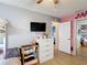 Bedroom featuring a bunk bed, ceiling fan, mounted tv, white dresser, and window at 1021 Whalebone Bay Dr, Kissimmee, FL 34741