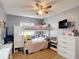 Bedroom featuring a bunk bed, ceiling fan, mounted tv, white dresser, and window at 1021 Whalebone Bay Dr, Kissimmee, FL 34741