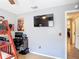 This bedroom features a wood floor, ceiling fan, mounted tv, and a wooden bunk bed at 1021 Whalebone Bay Dr, Kissimmee, FL 34741