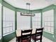 Bright breakfast nook with windows and a modern light fixture in the kitchen at 1021 Whalebone Bay Dr, Kissimmee, FL 34741