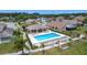 Aerial view of community pool, surrounded by well-manicured lawns and residential homes at 1021 Whalebone Bay Dr, Kissimmee, FL 34741